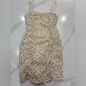 Cream colored mini dress with red flowers.